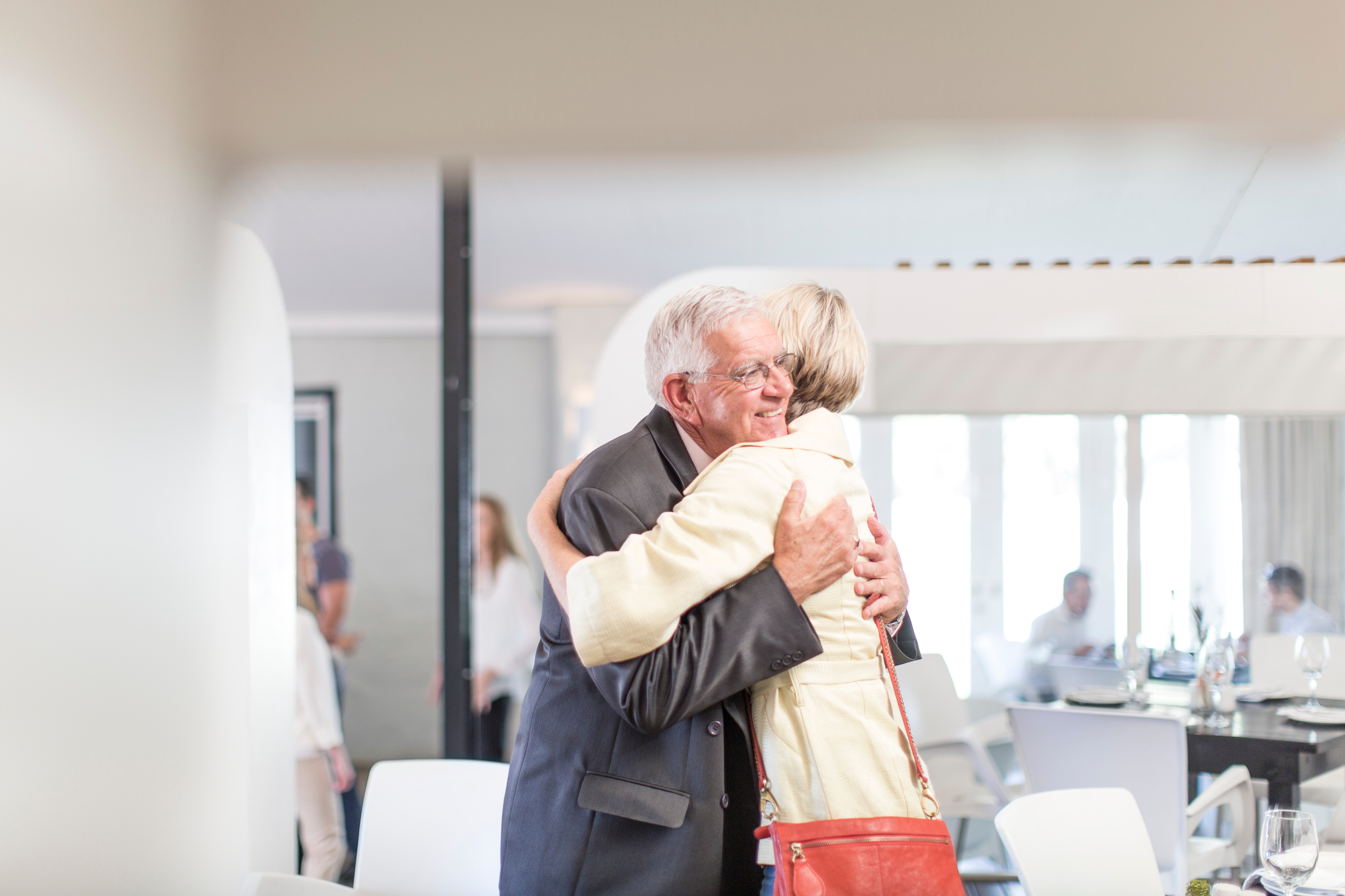 A client embraced by family